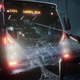 Miles holding a bus up with his webbing while civilians escape.
